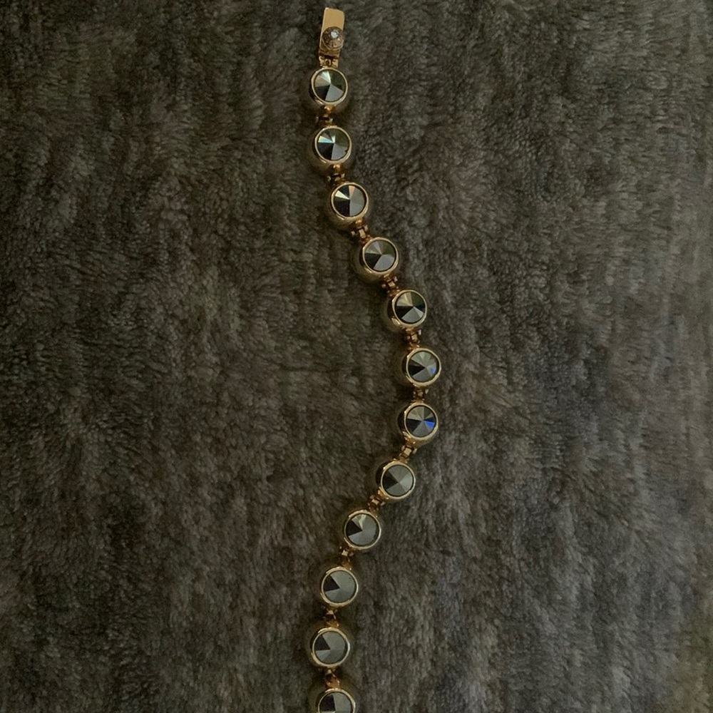Henri Bendel bracelet. Gun metal Swarovski crystals incased in gold.